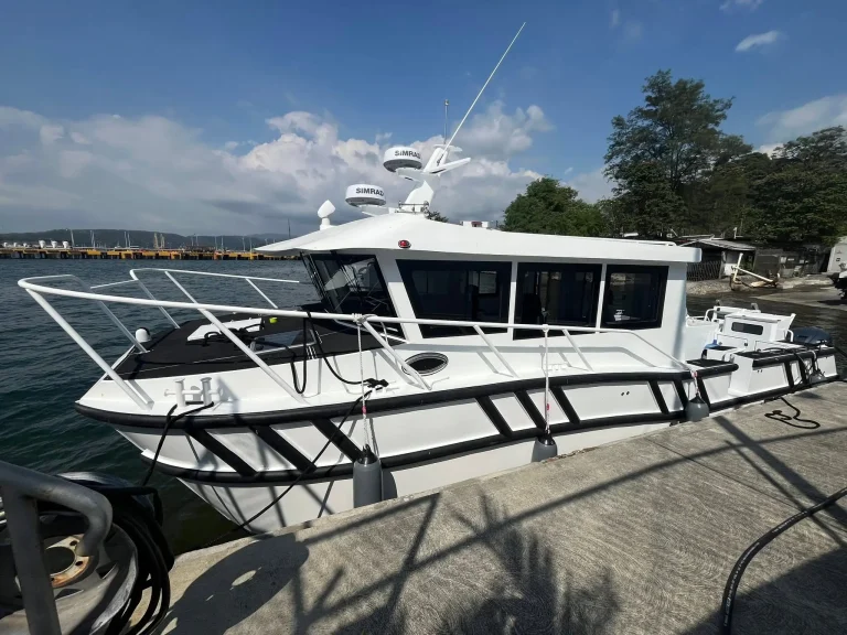 White plate aluminium passenger catamaran at anchor