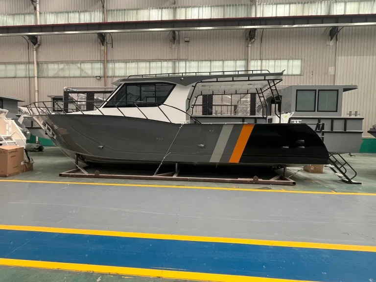 Work boat with orange stripe on the factory floor
