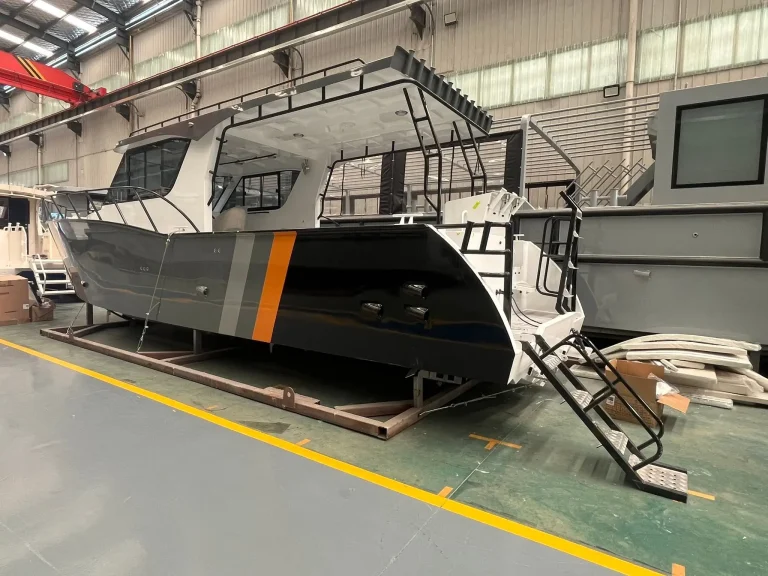 Work boat with orange stripe under construction