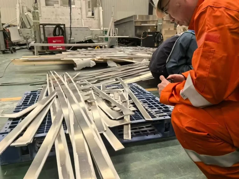 Worker preparing aluminium extrusions for a hull