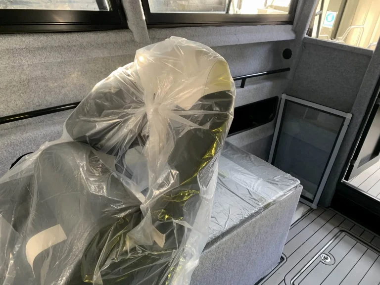 Wrapped helm seat inside a plate aluminium cabin