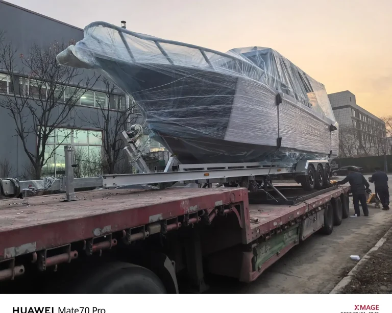 Wrapped plate aluminium boat on a low loader