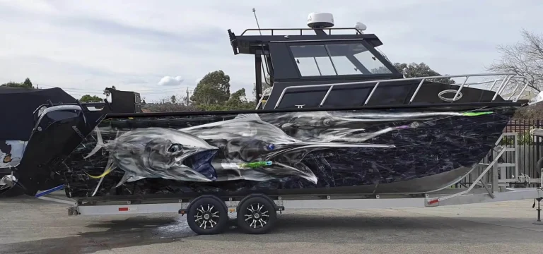 Wrapped plate aluminium hardtop boat on a trailer