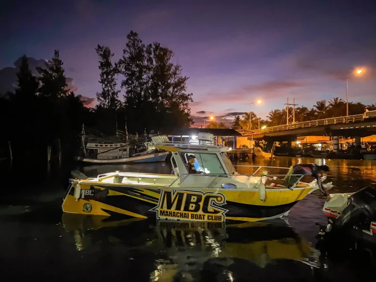 Yellow plate aluminium work boat at a wharf at dusk