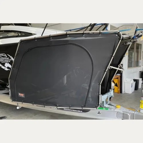 D-Flector mesh cover fitted to a boat stone guard, viewed from the rear quarter of the trailer