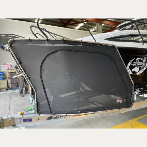 D-Flector mesh cover fitted to a boat stone guard frame on an aluminium trailer, side view in the workshop